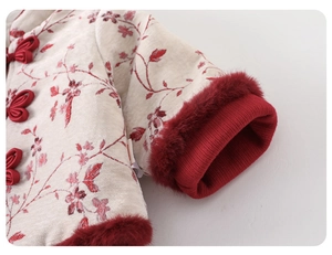 Detailed view of Chinese style winter clothes with red floral patterns and fur cuffs