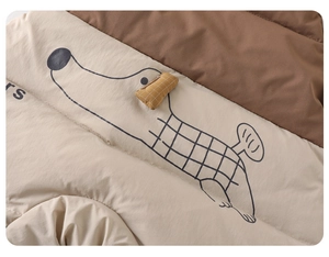 Detail showing the quilted toddler jumpsuit with a cute cartoon long dog illustration