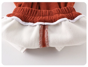 Close-up of baby girl's winter corduroy trousers waist with warm white fleece lining