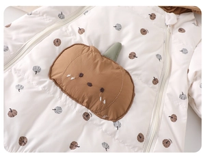 Detail of quilted baby romper with warm 3D pumpkin applique and all-over pumpkin patterns