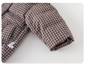 Detailed macro view of checkered baby down jacket with elastic windproof cuffs and pocket