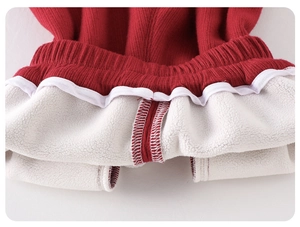 Detail of red ribbed knit pants with thick white fleece lining and elastic high waist