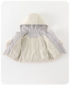 Detail of baby winter down coat featuring floral lining and adjustable hem drawstring