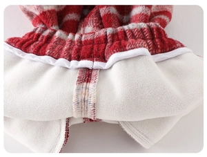 Close-up of baby winter fleece set showing red plaid pattern and thick white thermal lining