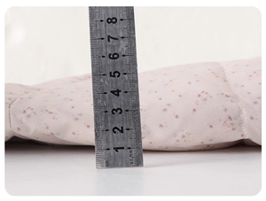 Macro shot of baby floral down jacket padding showing 4cm thickness with a ruler