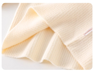 Close-up of thick off-white ribbed knit fabric detail for baby girls winter thermal clothing