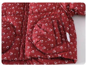 Detail of red floral print baby puffer jacket with soft white flowers and round pockets