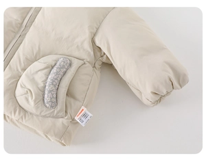 Detail view of quilted beige baby winter coat with floral trim pocket and warm fleece lining