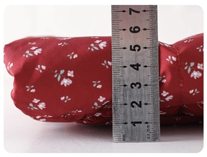 Detailed view showing the 6cm thickness of the warm burgundy floral down coat for babies