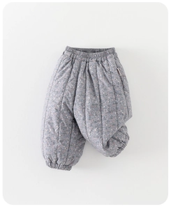 Detail of floral quilted winter pants for baby girls with elastic cuffs and warm lining