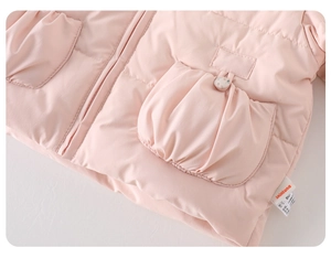 Detail of pink toddler down jacket showing quilted fabric zipper and wash care label