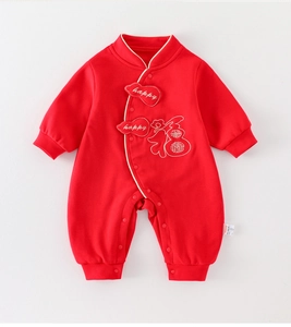 Detail of red newborn romper featuring happy embroidery and traditional Chinese Fu character