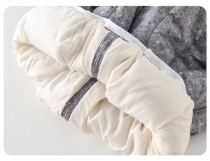 Detailed view of baby floral winter pants featuring thick fleece lining and soft padding