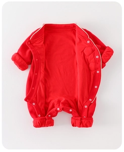 Close-up of red newborn cotton romper featuring snap buttons for easy dressing