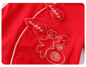 Detail of red newborn romper featuring rib-knit fabric with Fu character embroidery