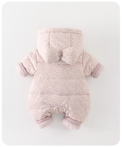 Flat lay of pink floral infant puffer jumpsuit with hooded bow and quilted texture