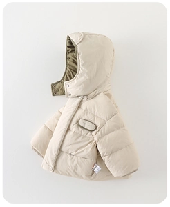 Close-up detail of warm winter baby puffer jacket with hood and olive contrast lining