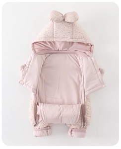 Detail of baby winter romper with delicate floral patterns and a cute bow on the hood