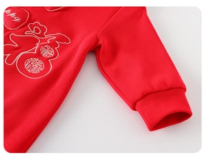 Detailed view of red baby romper with Fu embroidery and ribbed cuffs for New Year