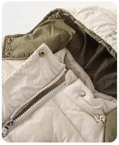 Close-up of winter baby hooded jacket with metal zipper and contrast lining detail