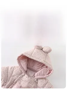 Detailed macro view of hooded baby romper with cute rabbit ears and floral pattern