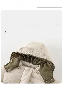Detail view of winter baby hooded puffer jacket with quilted beige fabric and olive lining