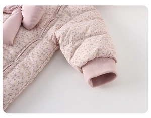 Detailed macro view of baby girl floral down romper featuring pink bow and windproof cuffs