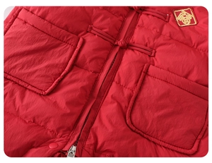 Détail de la combinaison d'hiver rouge pour bébé avec bouton chinois et broderie FU