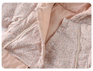Detail of pink floral baby winter romper with dual zipper and snap button closure