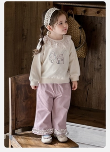 Close-up of girls' ruffle collar sweatshirt with embroidery and matching floral hem pants