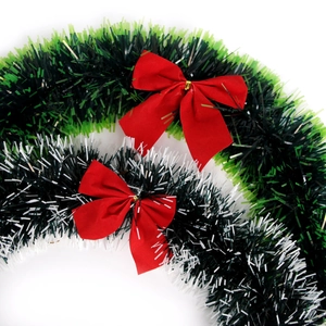 Green and white Christmas tinsel garland with red bows for holiday party home decoration