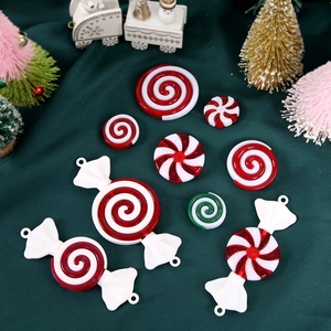 Red and white Christmas candy tree ornaments set with peppermint swirl designs