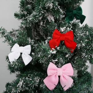 Festive velvet Christmas tree bow ornaments in red, white, pink, and green colors