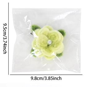 Detailed size view of a handmade plush yellow and green flower hair clip with pearl