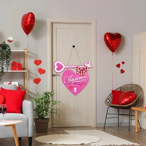Pink heart wooden Valentine's Day door hanger with ribbon and key motif on white door