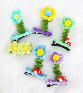 Detail of 6 handmade plush flower hair clips with colorful petals and mushroom accents