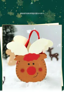 Detail of reindeer felt gift bag with red nose and stitched antlers in a festive setting