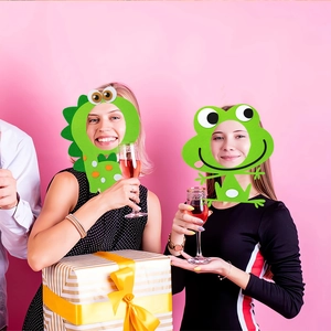 Detail of green felt dinosaur and frog party masks for kids birthday and role play events