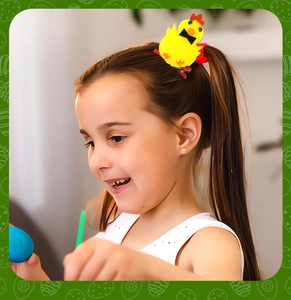 Close-up of a plush yellow Easter chick hair clip worn on a child's braided hair