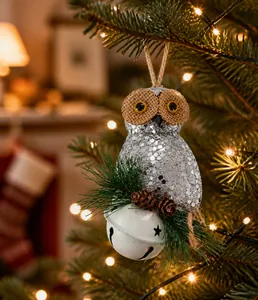Close-up of sparkling sequin owl ornament with pine cone detail and a white star bell
