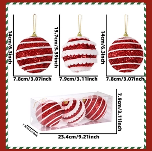Detail view of red and white glitter Christmas ornaments with size specs in a clear gift box