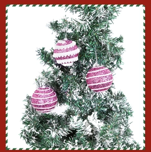 Close-up of glittery rose purple and white striped Christmas ball ornaments on a tree branch