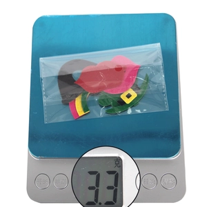 Close-up of Saint Patrick's Day photo props in clear bag showing weight on a digital scale