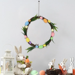Easter wreath with colorful speckled eggs and green leaves on a natural twig base