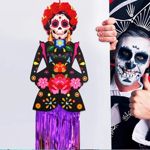 Detail of Day of the Dead skeleton hanging decoration with red roses and purple fringes