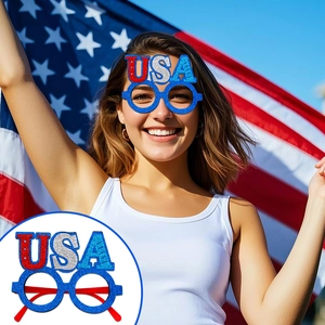 Close-up of Independence Day party glasses with red white and blue glitter USA letters