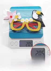 Detail showing tropical bird felt party glasses with flowers being weighed on a scale