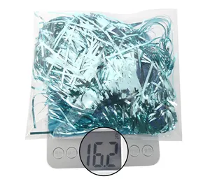 Close-up of 16.2g light blue metallic tinsel filler on a digital scale for weight measurement