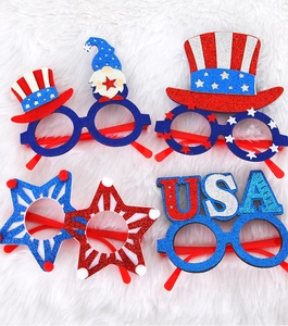 Detail of four patriotic July 4th party glasses with USA stars and glitter on white fur