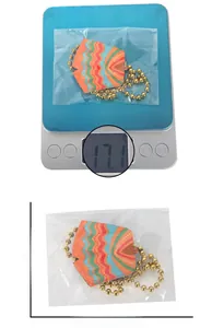 Cinco de Mayo cactus pendant size and weight details on a jewelry scale and white backdrop